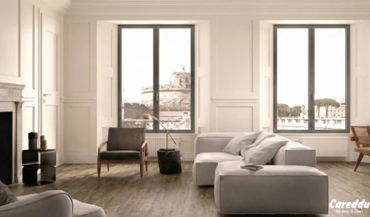 Soggiorno moderno e luminoso con nuovi infissi grigi dal profilo sottile e vista panoramica su Castel Sant'Angelo.